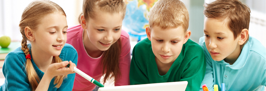 Four students looking at a computer